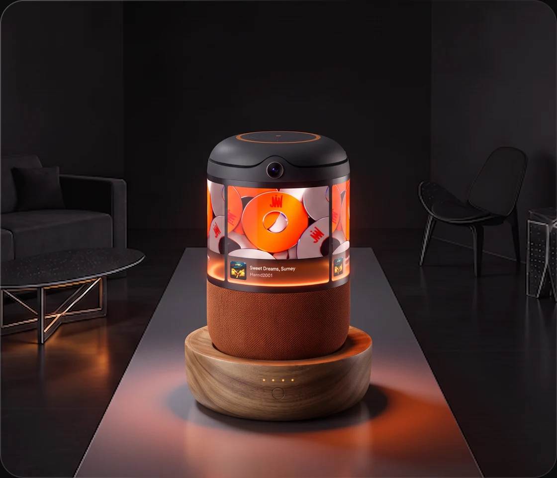 Buddy on a table in a dim living room showing a JGGL App post with an orange CD cover on the dome — phone created, Buddy brought to life